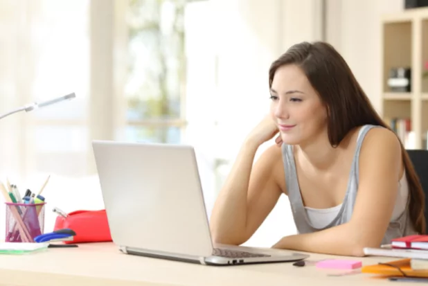 A young woman sitting at a laptop. Healthcare technology trends 2025